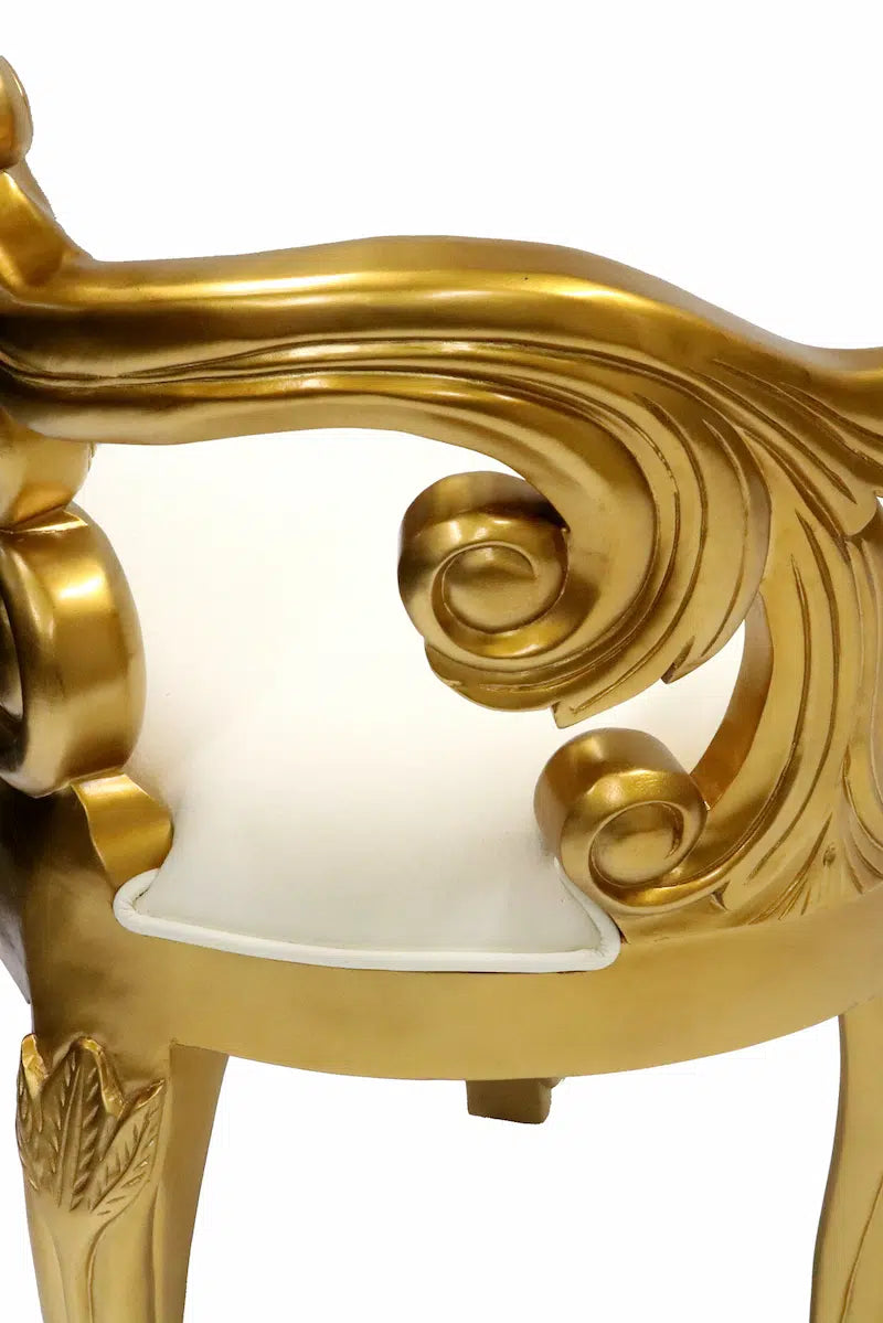 Gold ornate chair with white cushion on a white background
