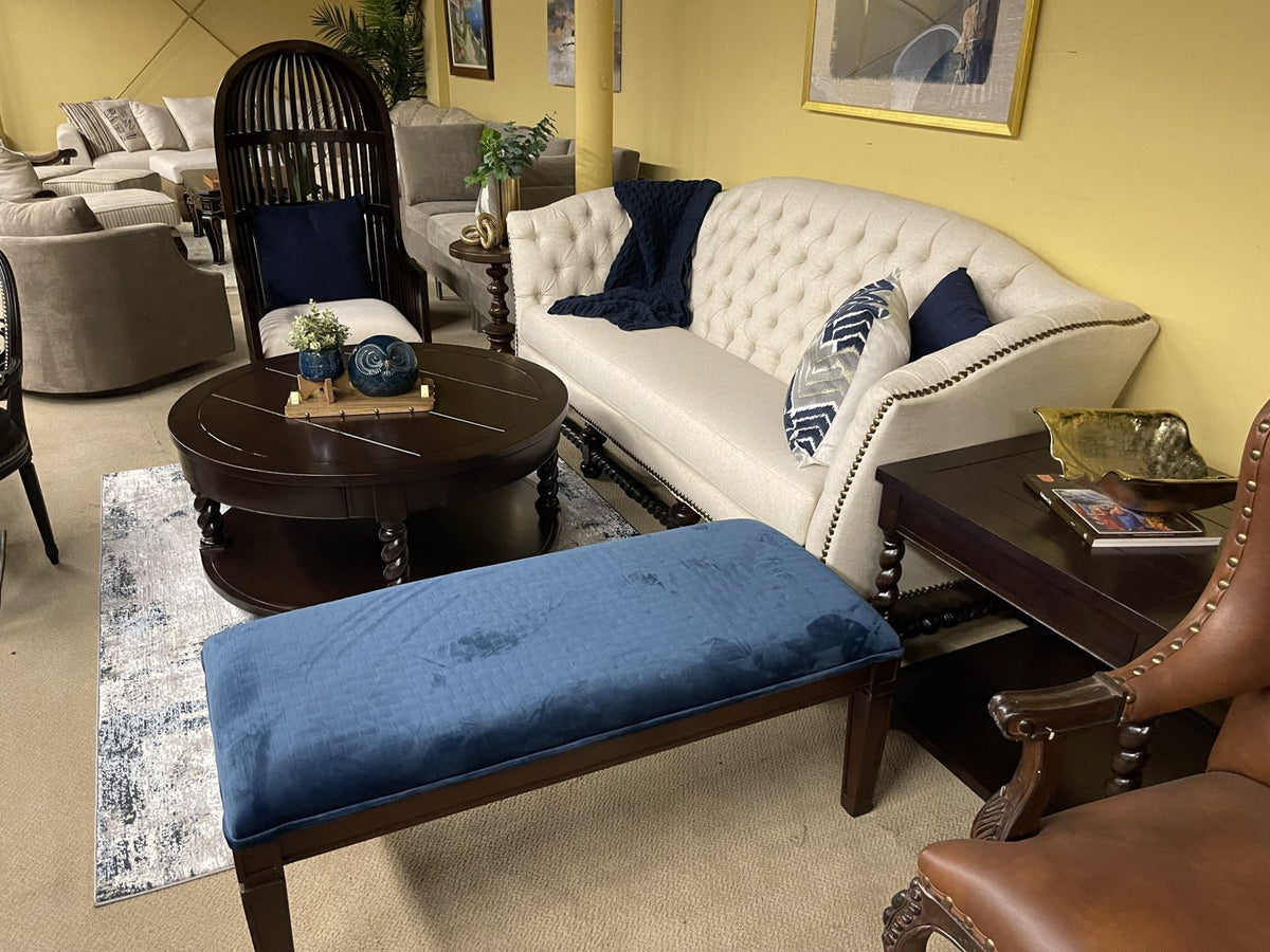 Tufted cream sofa and blue velvet bench in the Sigla showroom