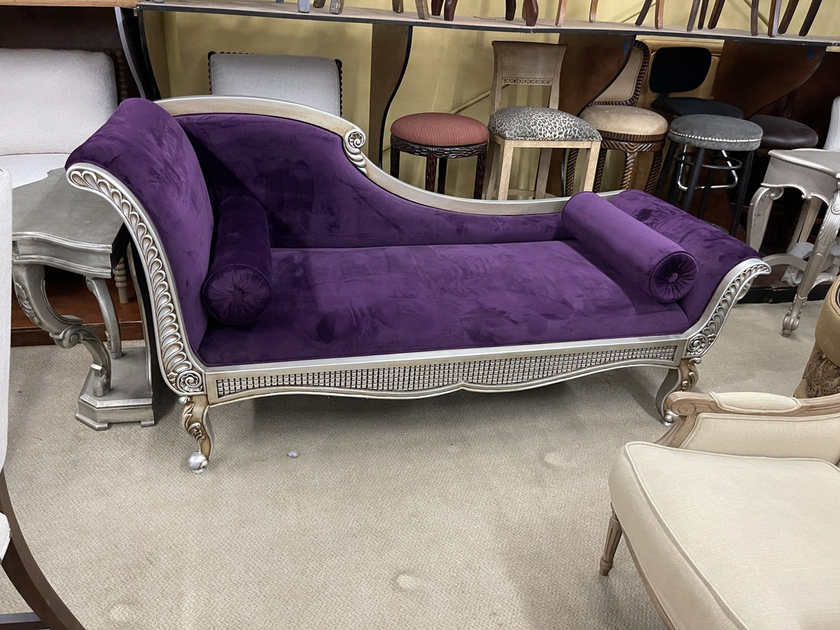 Purple velvet chaise lounge with a silver carved frame in the Sigla showroom