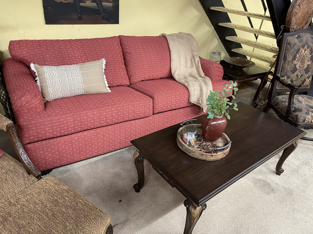 Coral sofa and dark wood coffee table in the Sigla showroom
