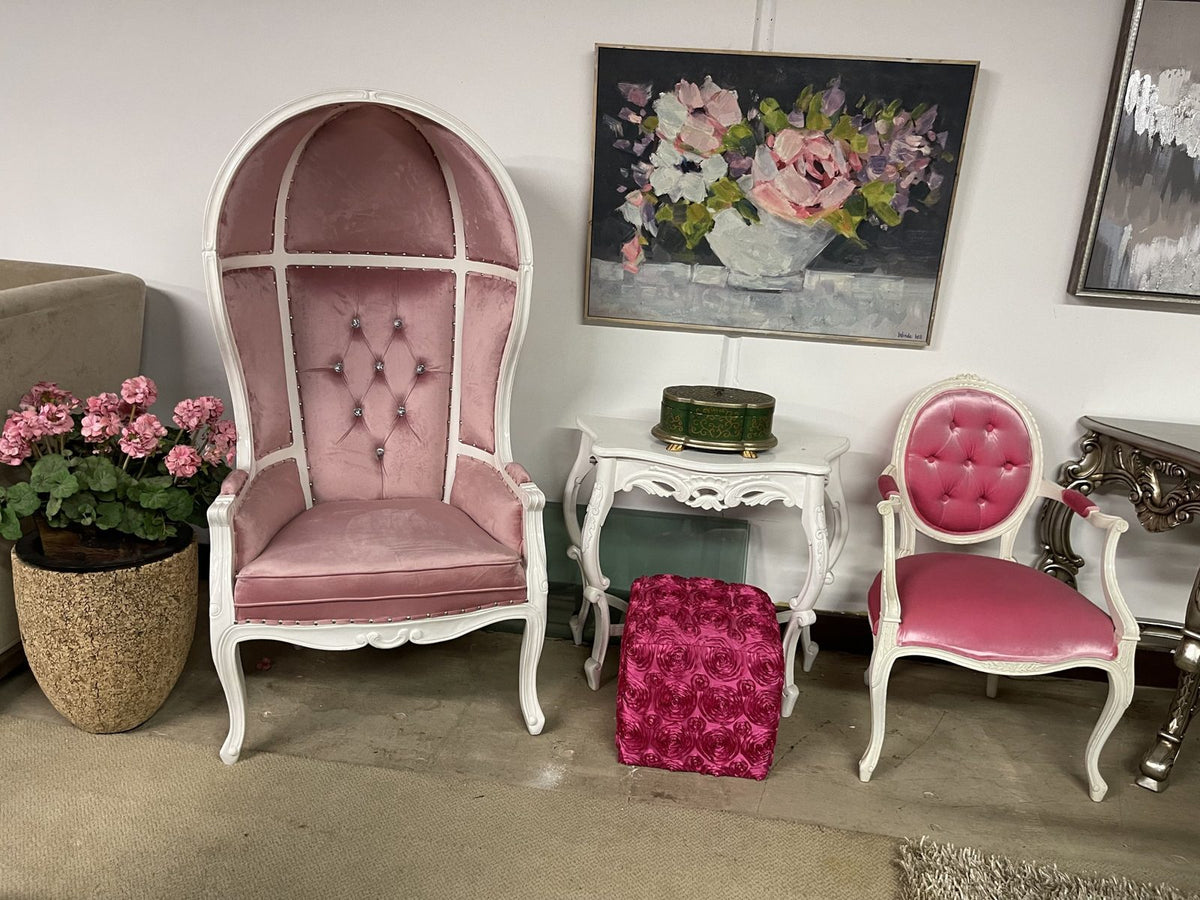 Pink velvet canopy chair and side chair with white frames in the Sigla showroom