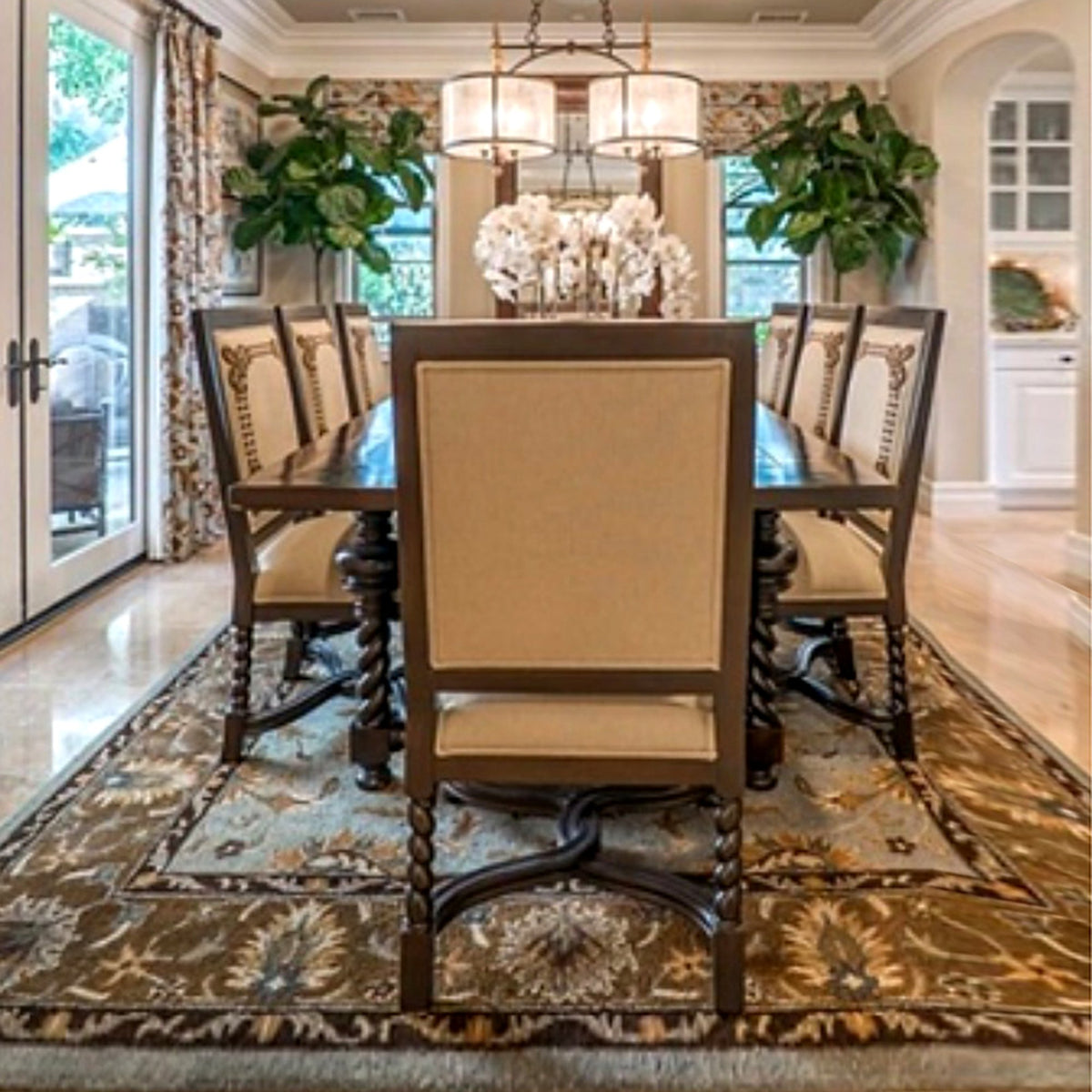 Dark wood dining table with upholstered chairs in a dining room